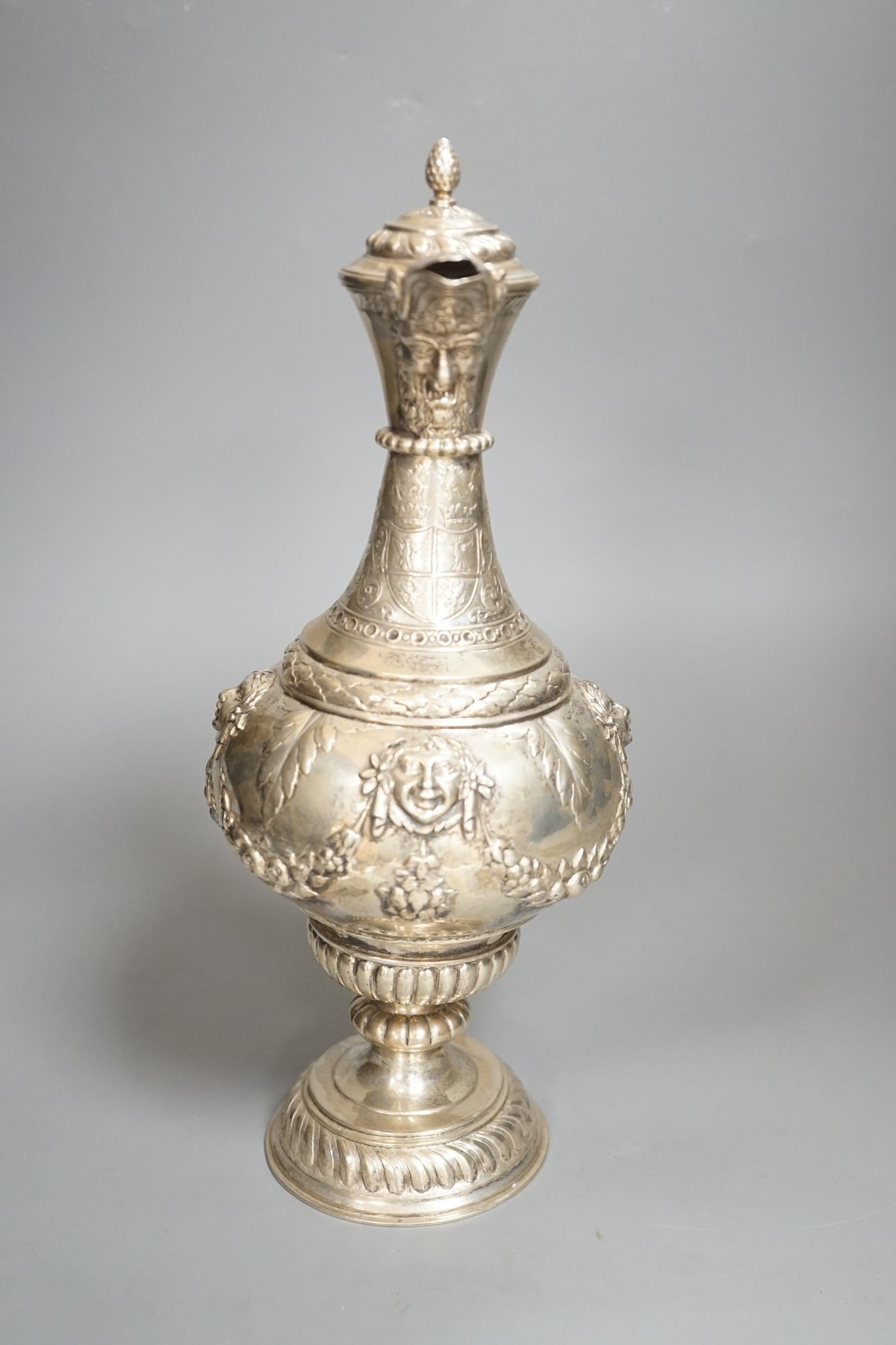A 19th century Continental white metal wine ewer, embossed with swags and masks, height 29.9cm, 16.5oz.